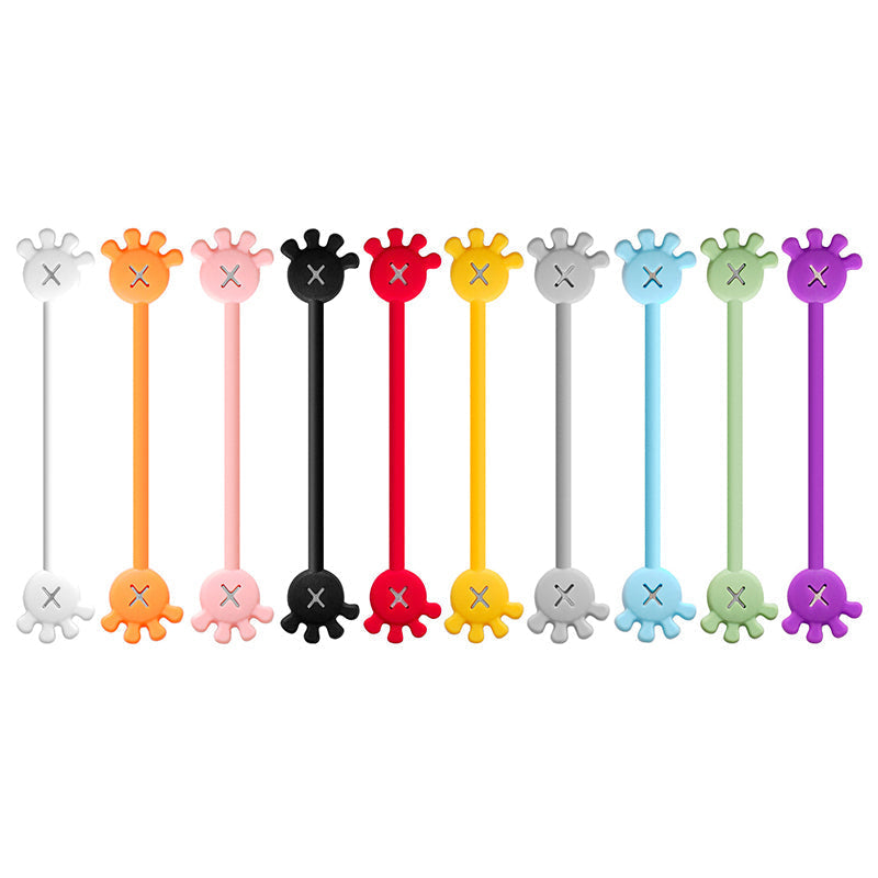 Assorted magnetic silicone cable organizer clips on a bulletin board, demonstration of magnetic strength.