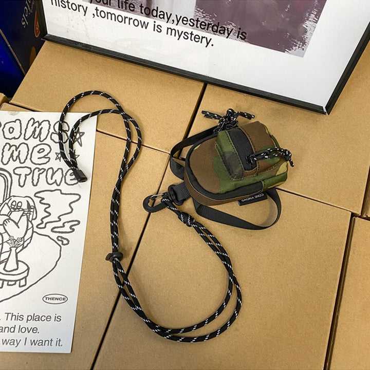 Durable oxford cloth mini bag, designed for versatile unisex use as a pendant or crossbody.