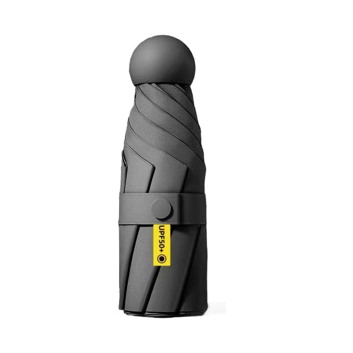 Mini foldable umbrella with a wrist strap, convenient for hands-free carrying, travel gear