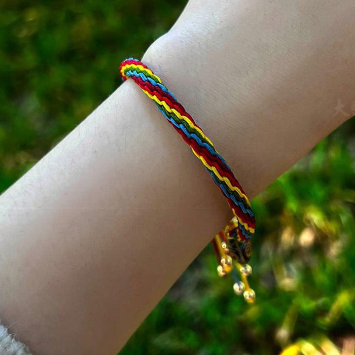 Hand modeling a Unisex Mythical Reincarnation adjustable cord bracelet, symbolic jewelry