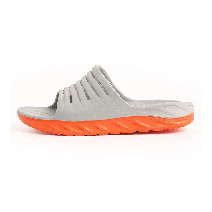 Stylish unisex comfort slides with orthopedic design for superior arch support and effective heel pain relief.
