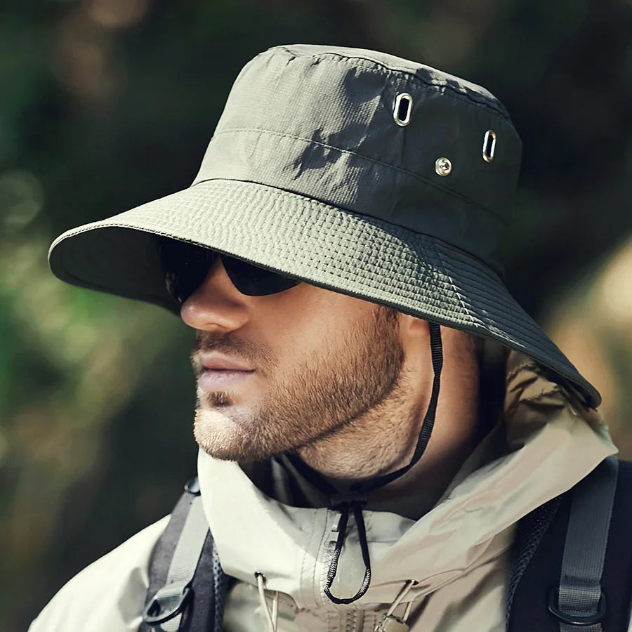 Adjustable wide brim bucket hat in a solid color, ideal for unisex sun protection during travel