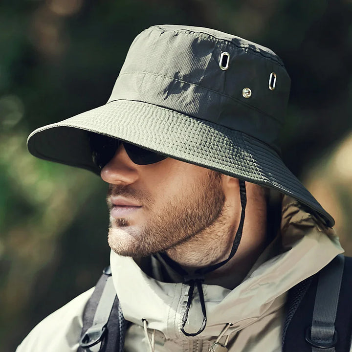 Adjustable wide brim bucket hat in a solid color, ideal for unisex sun protection during travel
