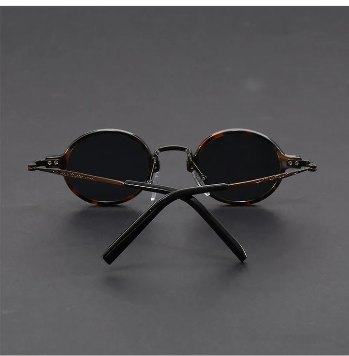 A pair of unisex oval vintage sunglasses showcasing their unique shape and high-quality precision.