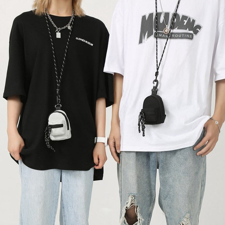 Sleek black Oxford Cloth mini bag, functioning as a unisex pendant, crossbody, or small waist pack.