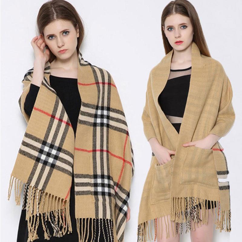 Close-up of the soft cashmere-feel fabric of a unisex plaid wrap shawl with integrated pockets