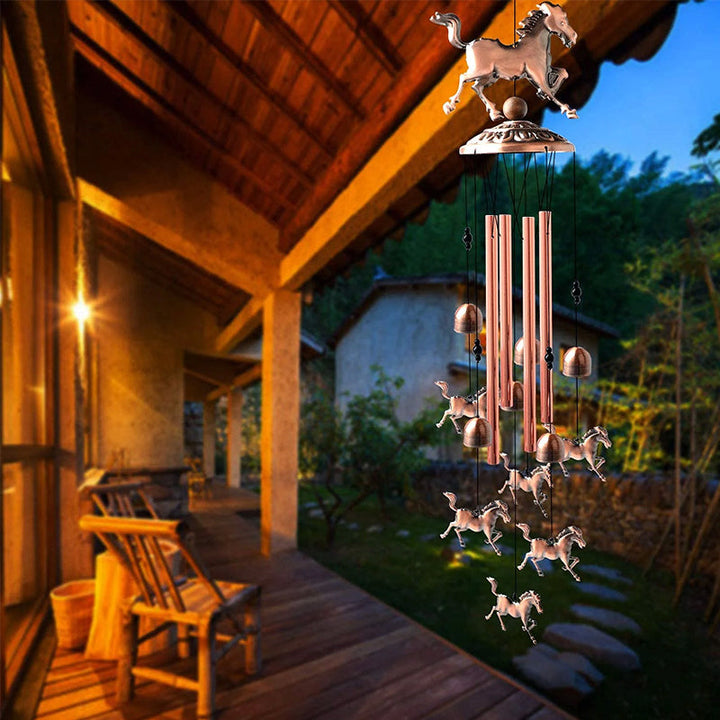 Outdoor view of a decorative retro bronze animal wind chime, hanging in a garden, home decor item
