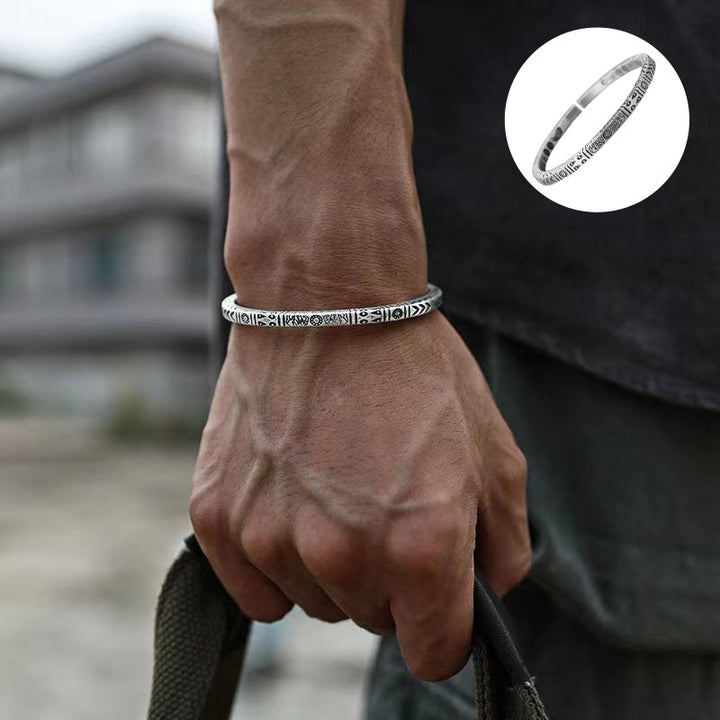 Front view of a unisex copper bangle bracelet with a prominent retro ethnic totem design