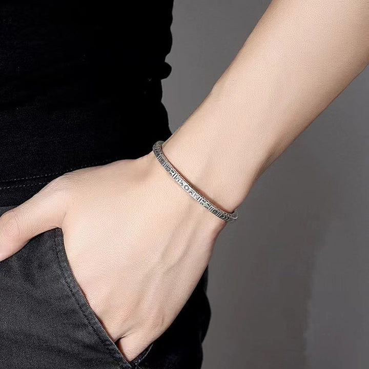 Detailed view of the ethnic totem pattern on a unisex copper bangle bracelet, vintage appeal