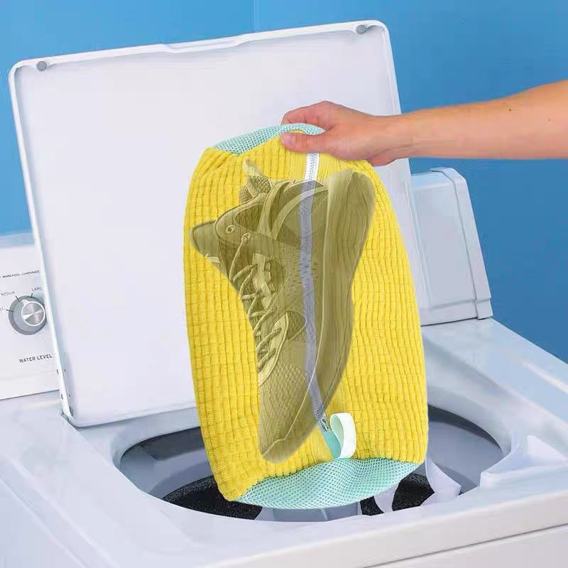 Unisex shoe wash bag shown hanging to dry, demonstrating its quick-drying polyester material
