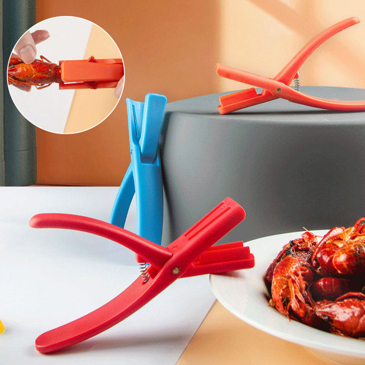 Close-up of red plastic Seafood Sheller Tool, ergonomic grip for easy crawfish peeling