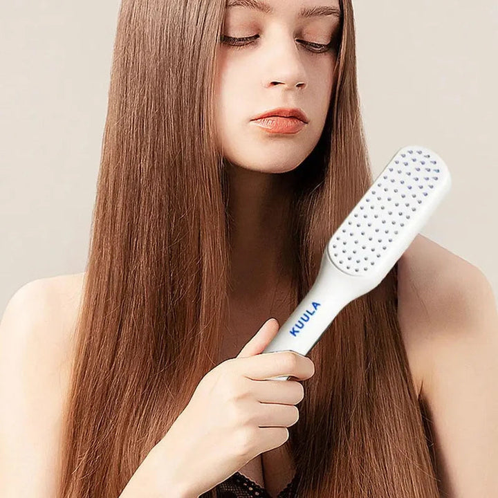 Person demonstrating the self-cleaning function of the innovative hair brush, easy maintenance