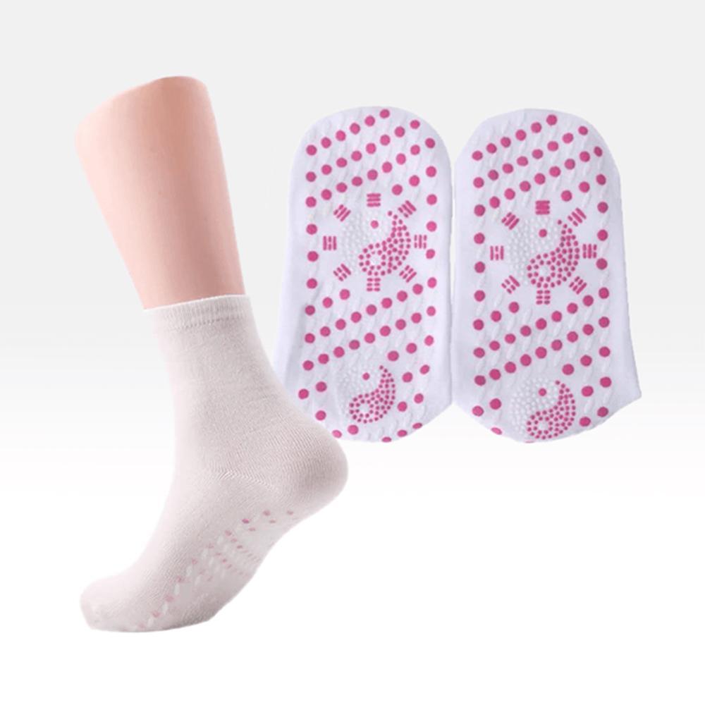 Person relaxing with self-heating tourmaline socks on, enjoying foot comfort and therapeutic warmth.