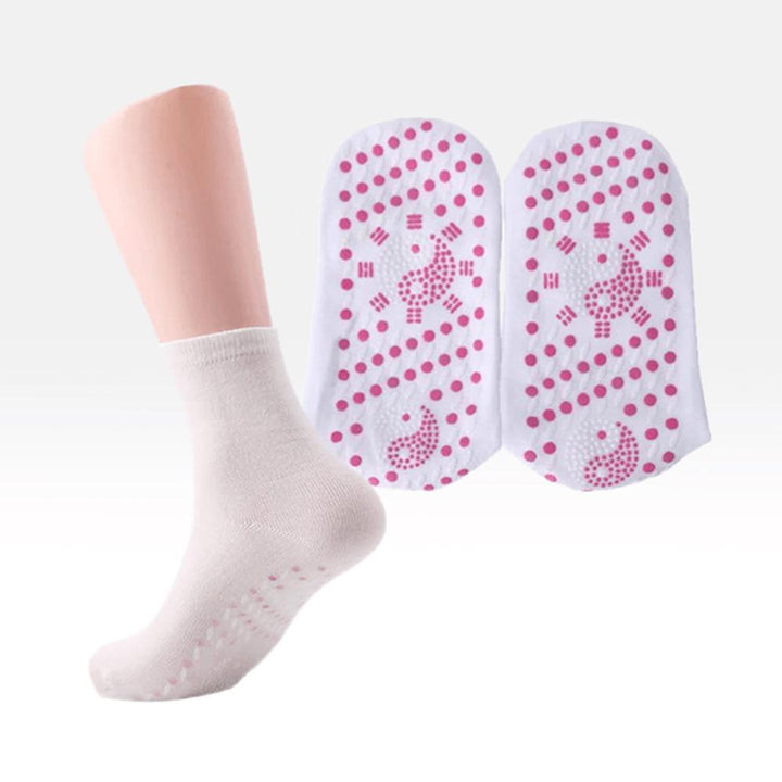 Person relaxing with self-heating tourmaline socks on, enjoying foot comfort and therapeutic warmth.