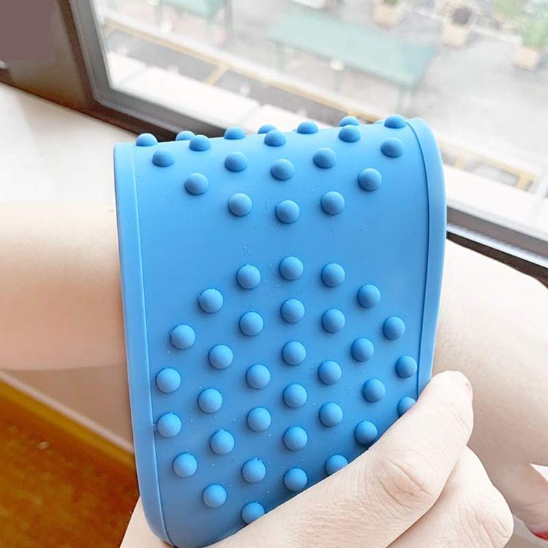 Detailed view of the silicone scrubber's handle, designed for a firm grip during bathing