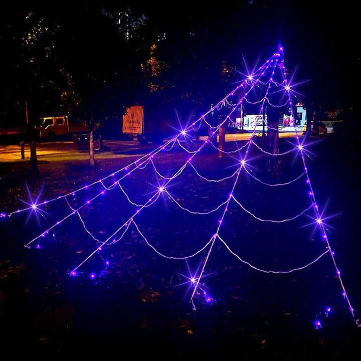 Lifestyle shot of the Spider Web Hanging Light used as a centerpiece for Halloween party decor.