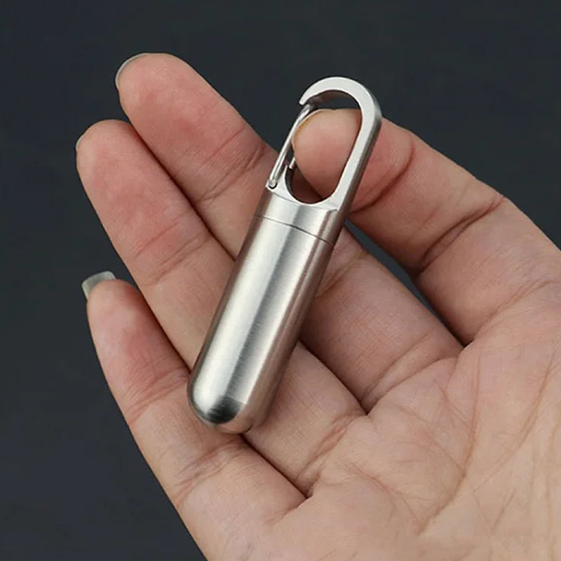 Compact travel pill container, stainless steel and waterproof, attached to a keychain