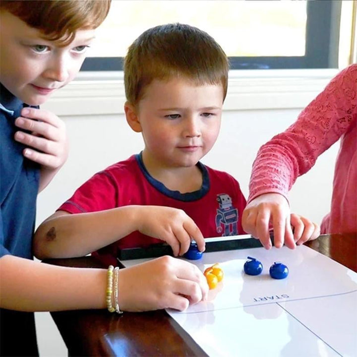 Unisex Tabletop Curling Game set up, ready for family fun on a wooden table. Indoor strategy board game.