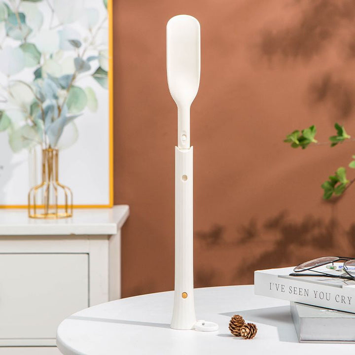 Metallic telescopic shoe horn, showcasing its adjustable length & durable footwear tool design