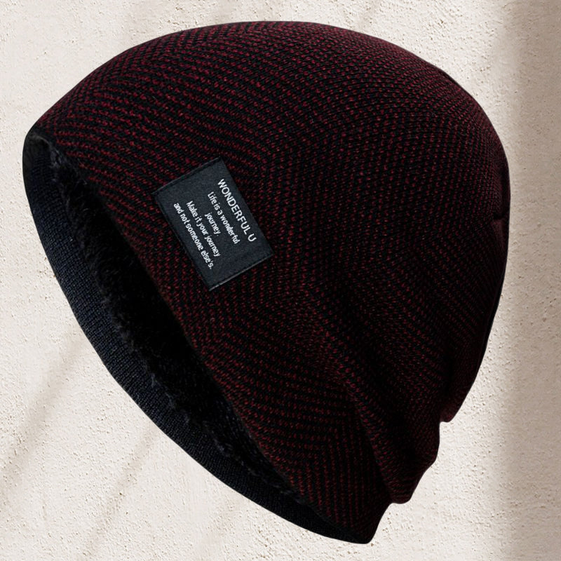 Detail shot of the thermal lining inside a unisex knit beanie hat, showing enhanced warmth for winter.