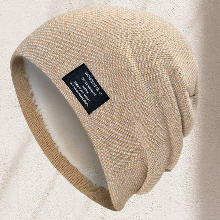 Folded unisex thermal knit beanie hat in a vibrant red, highlighting its thick, warm material.