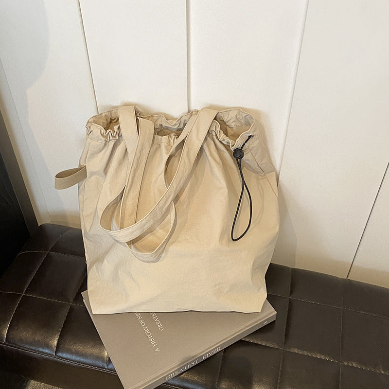 Front view of black ultra-light messenger bag, casual nylon, perfect for travel & everyday carry