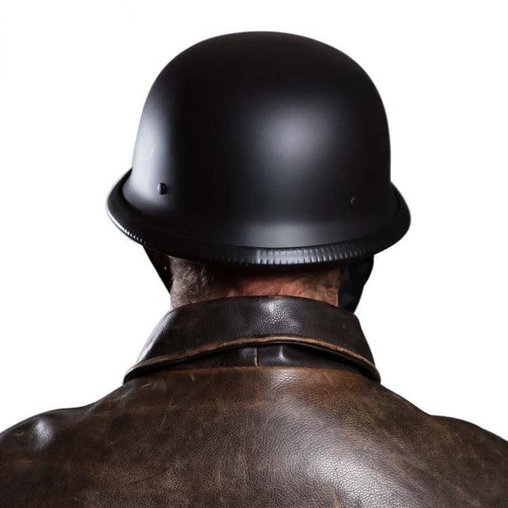 Rider wearing a unisex vintage half-face motorcycle helmet, classic style, open-face protection.