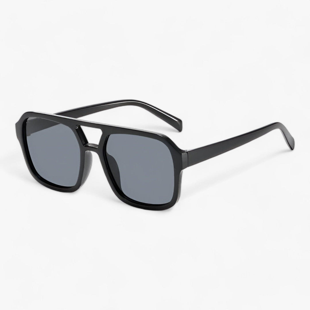 Unisex vintage oversized square sunglasses. Trendy black frames provide stylish UV protection.