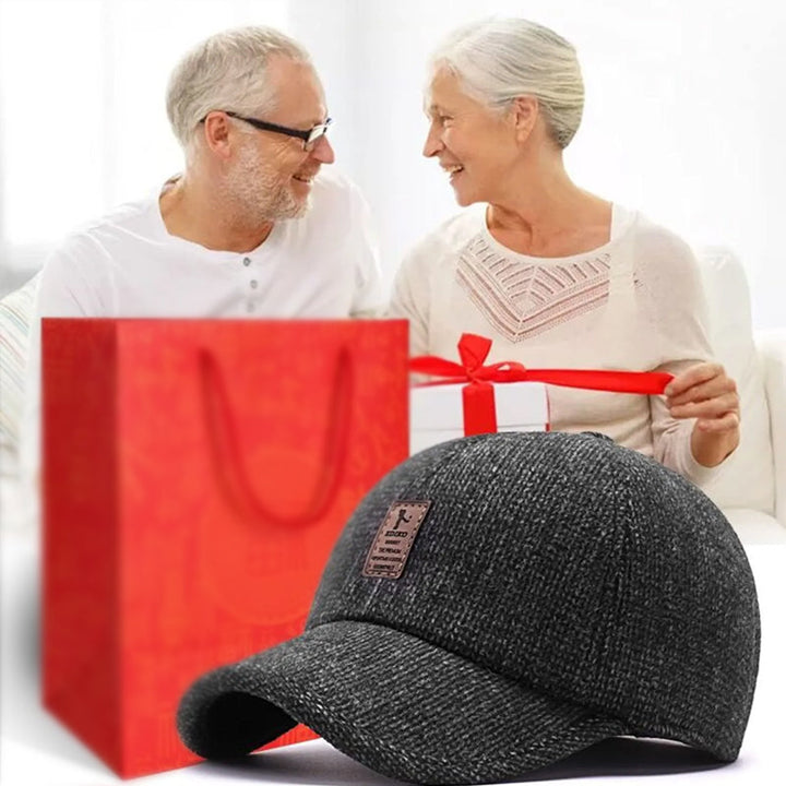 Unisex winter baseball cap on a snowy background, burgundy, emphasizing its warmth and winter functionality
