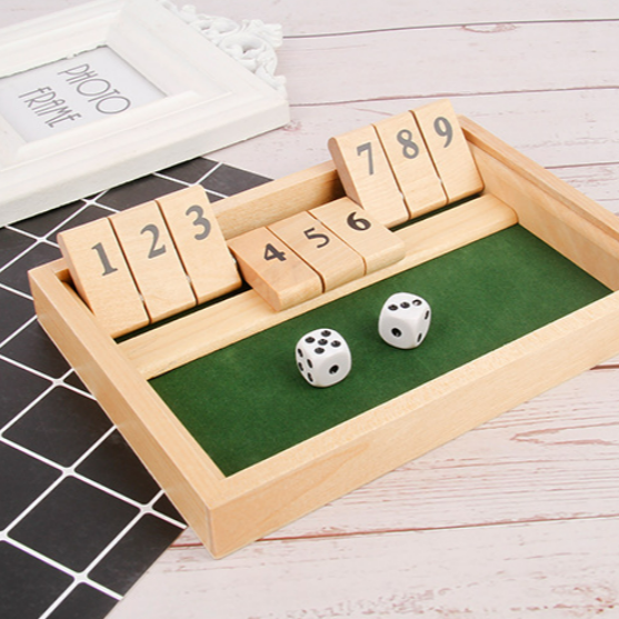 Adults engaged in a competitive dice math game, a perfect party or travel game