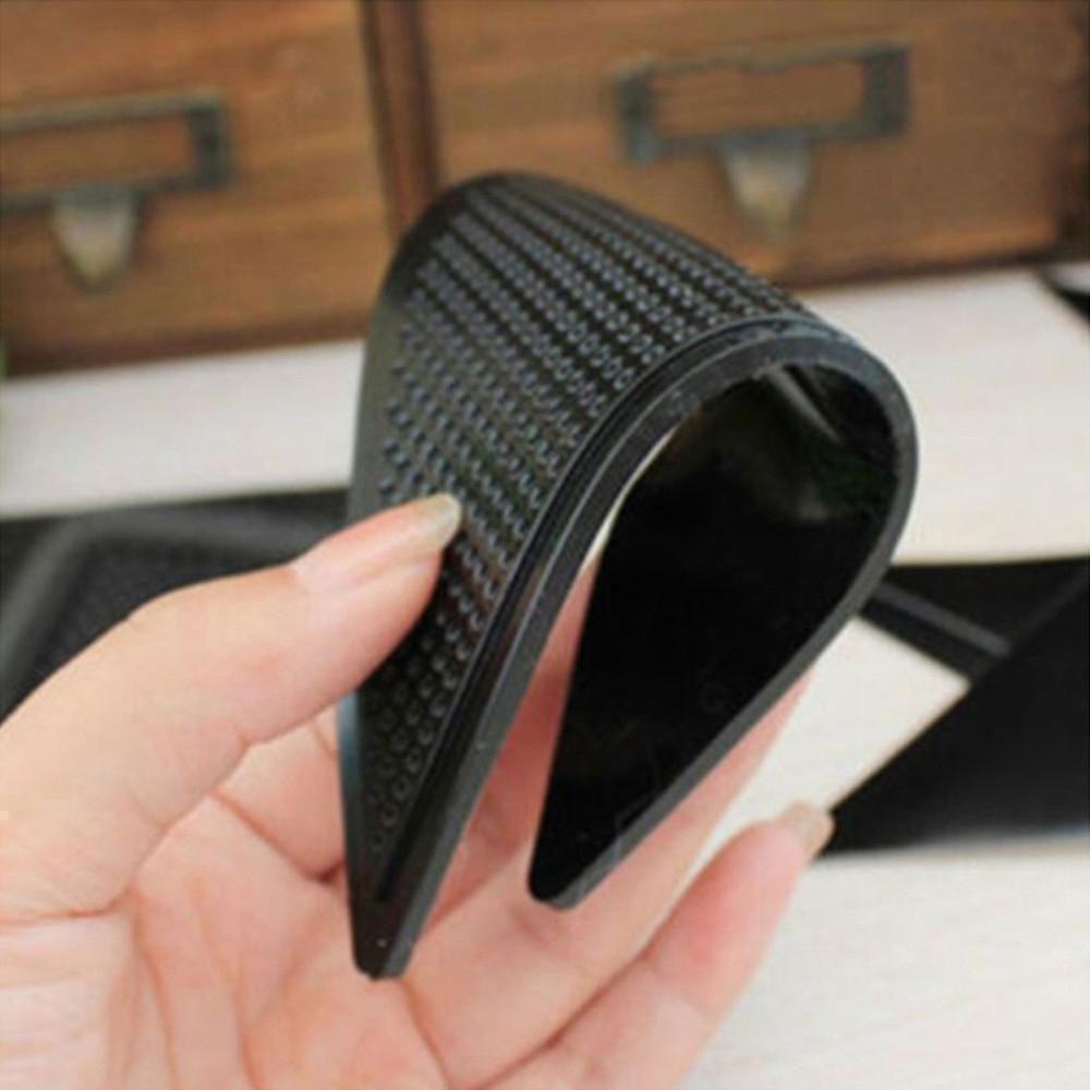 Close-up of a non-slip rug pad gripper, triangular design, adherence to carpet corners for stability