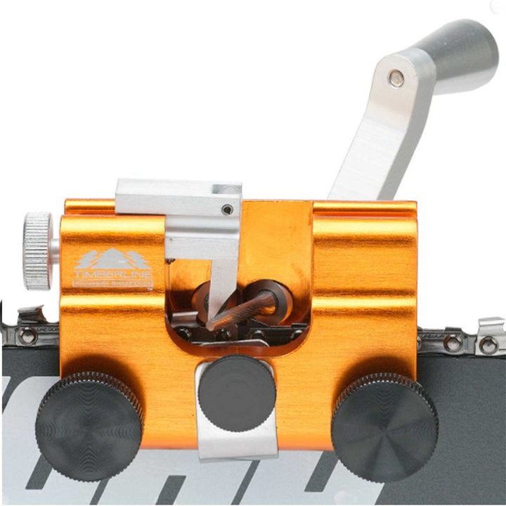 Close-up of chainsaw chain sharpening jig clamping mechanism, securing chain for sharpening.