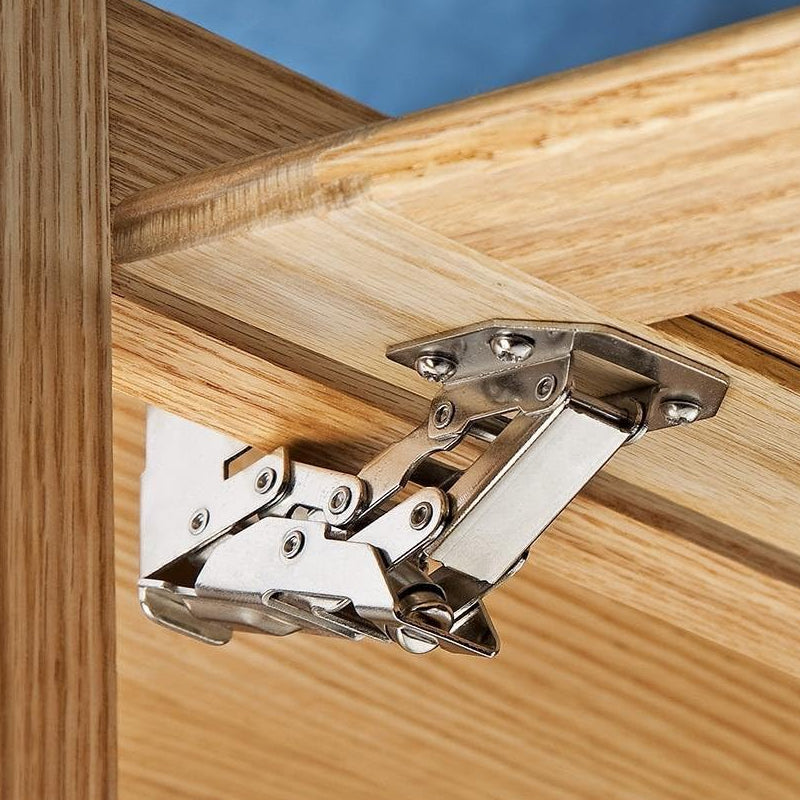 Installation view of a universal drill-free cabinet door hinge on a wooden kitchen cabinet
