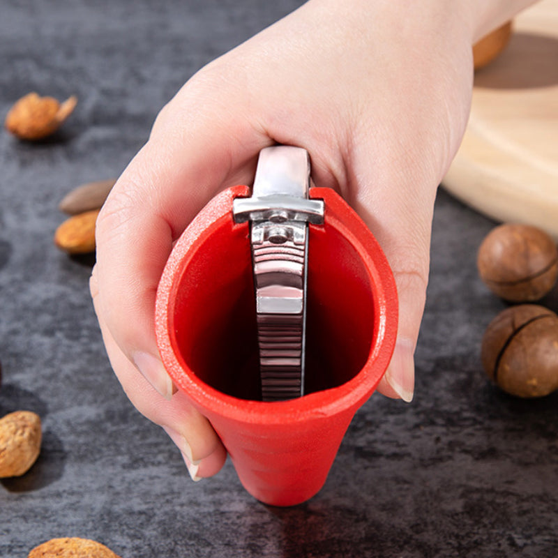Hand holding the ergonomic nut cracker, demonstrating its comfortable grip for easy nut opening.