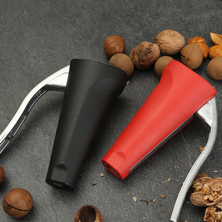 Nut cracker shown next to a pile of walnuts and pecans, highlighting its intended use as a nut opener.