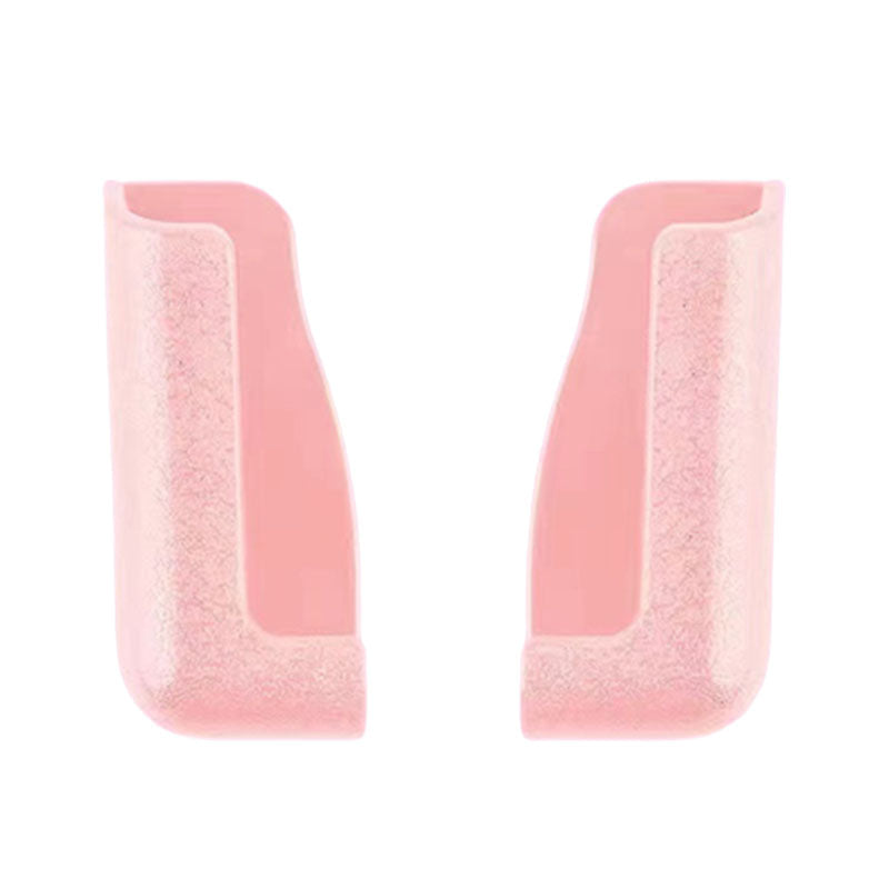 Set of two universal sticky phone holders, one black and one white, for various devices