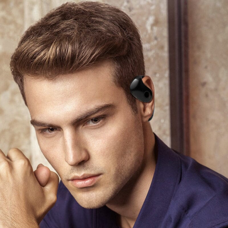 Hands holding Universal wireless earbuds and their compact charging case