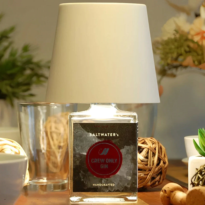 Cordless bottle lamp, black, illuminating a cozy living space, rechargeable via USB