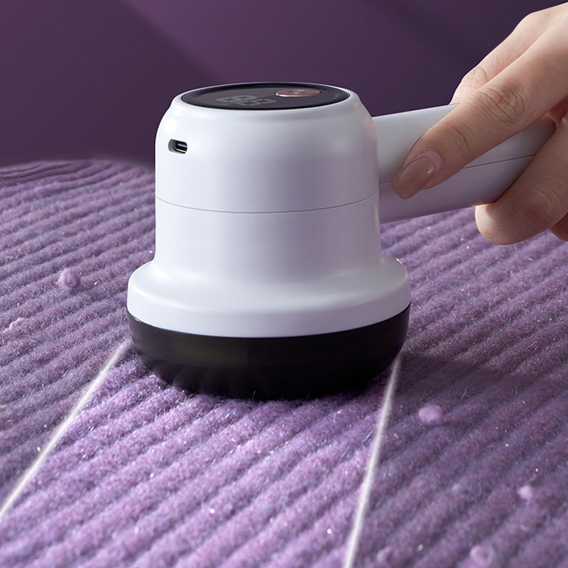 Fabric defuzzer kit with charging cable and cleaning brush, complete home essentials set.