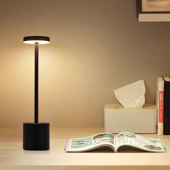 Person adjust the brightness of the portable LED table lamp with a simple touch