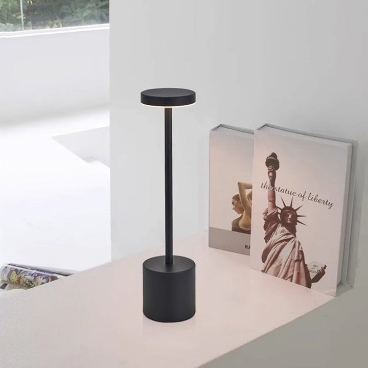 Rechargeable LED lamp illuminating a dining table, ideal for indoor and outdoor entertaining