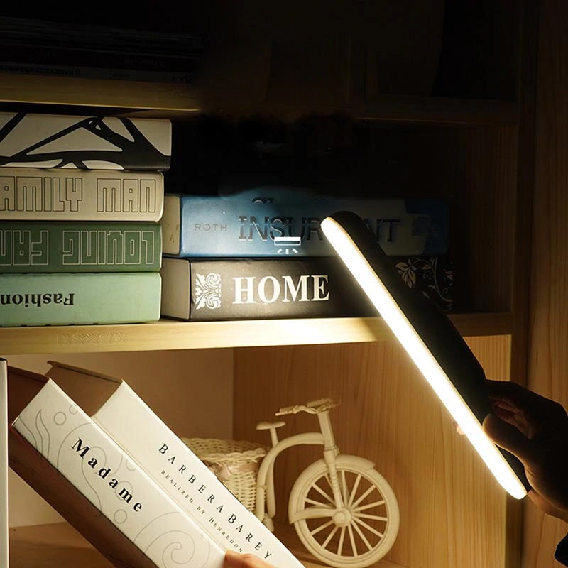 Close-up of USB rechargeable magnetic reading lamp showing LED lights and slim design