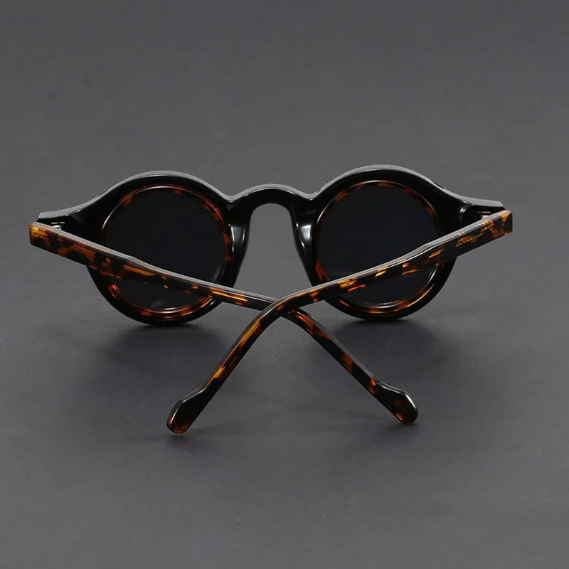 Stack of Velari unisex round frame sunglasses in various colors and finishes, fashionable eyewear.