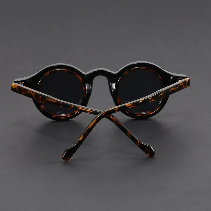 Stack of Velari unisex round frame sunglasses in various colors and finishes, fashionable eyewear.