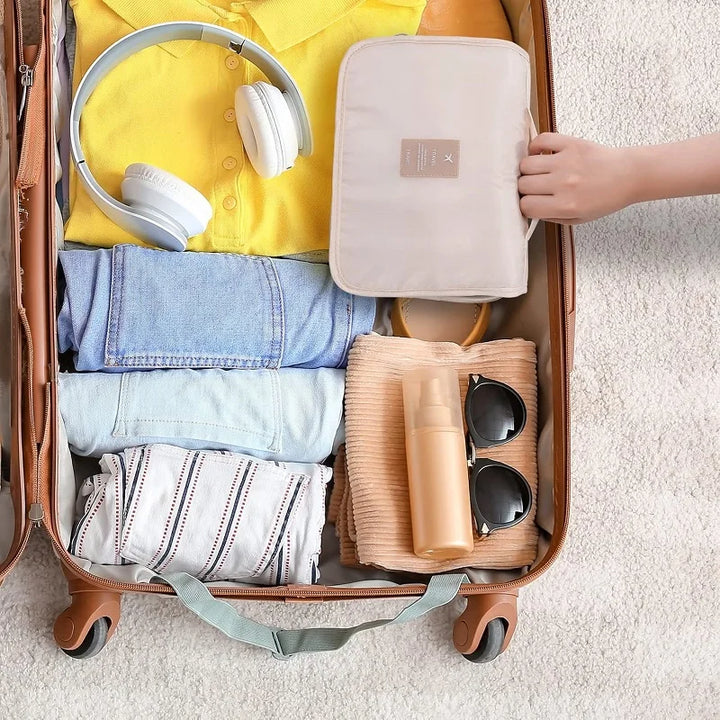 Compact travel cosmetic organizer bag, featuring multiple compartments for toiletries and makeup.