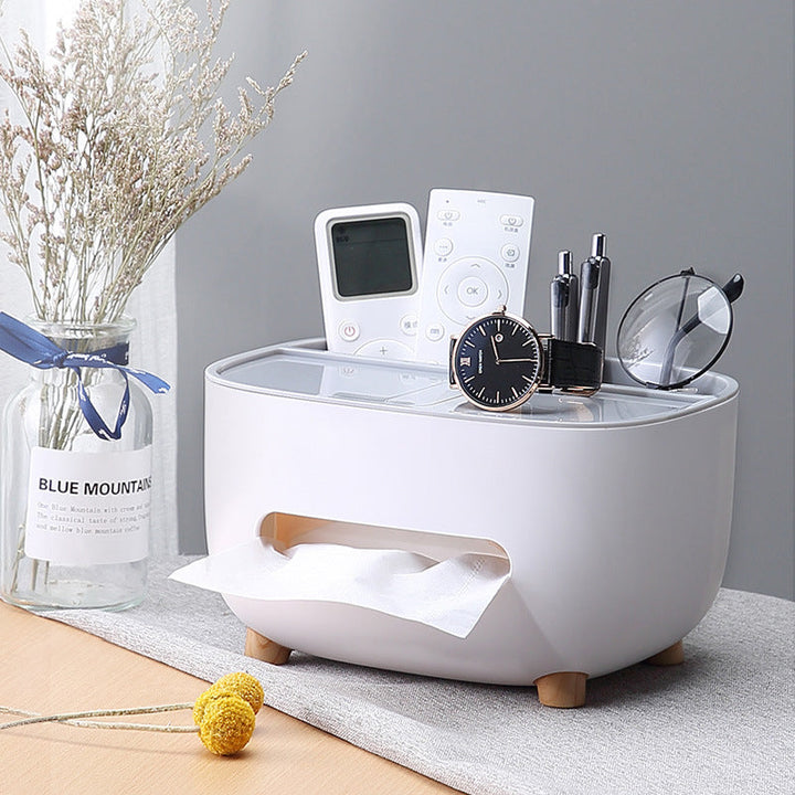 Tissue box with storage caddy, perfect for organizing remote controls, pens, and paperclips.