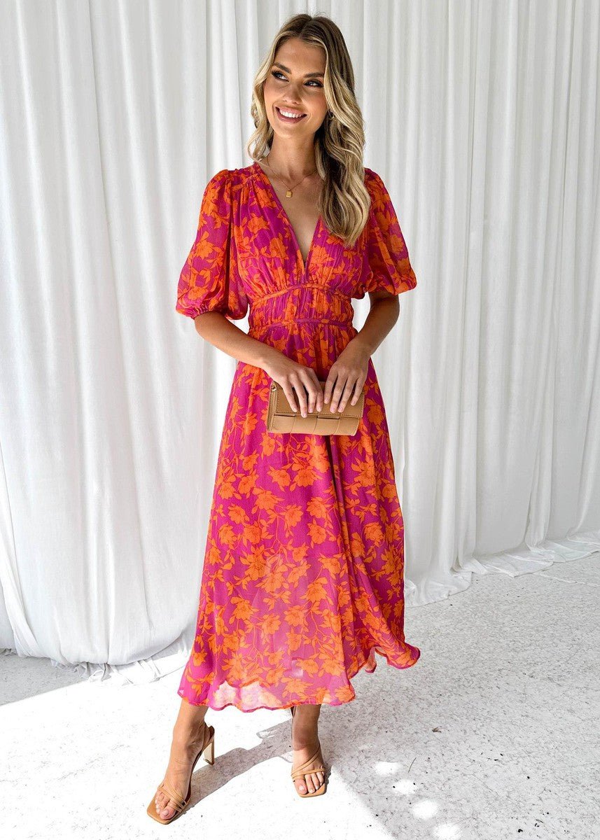 Vibrant pink orange floral maxi dress for women, featuring a flattering V-neck and delicate flutter sleeves. Summer style.
