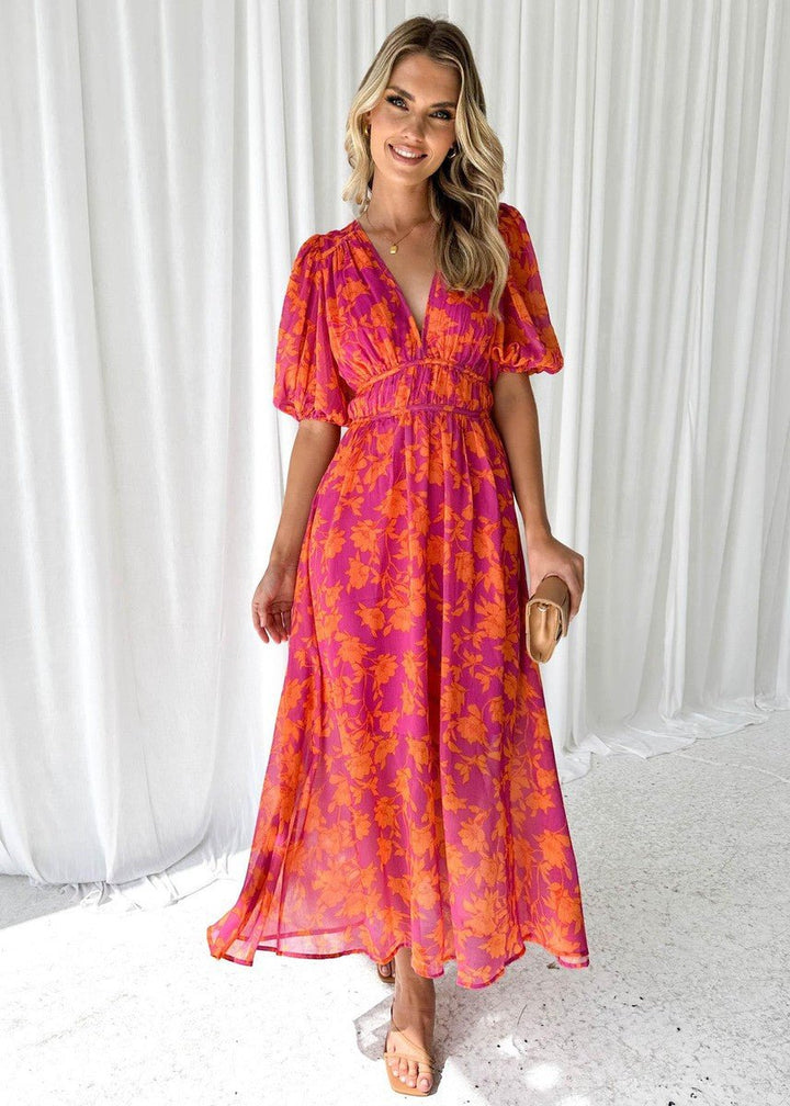 Casual women's vibrant pink orange floral maxi dress. V-neck design with flutter sleeves, great for everyday wear.