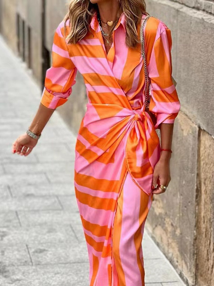 Statement women's vibrant printed wrap dress. Stand out with this chic, colorful piece for summer fashion.