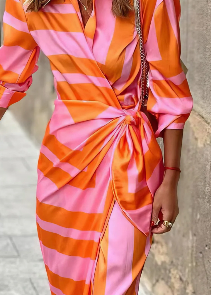Women's colorful vibrant printed wrap dress, perfect for summer. A chic, flattering statement piece.